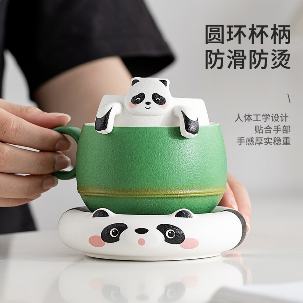 Green mug with panda design held by a person, on a light background