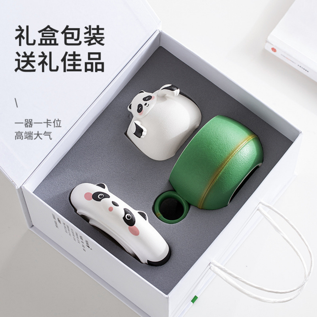 Ceramic tea set with panda designs in a box, featuring text on a white background.