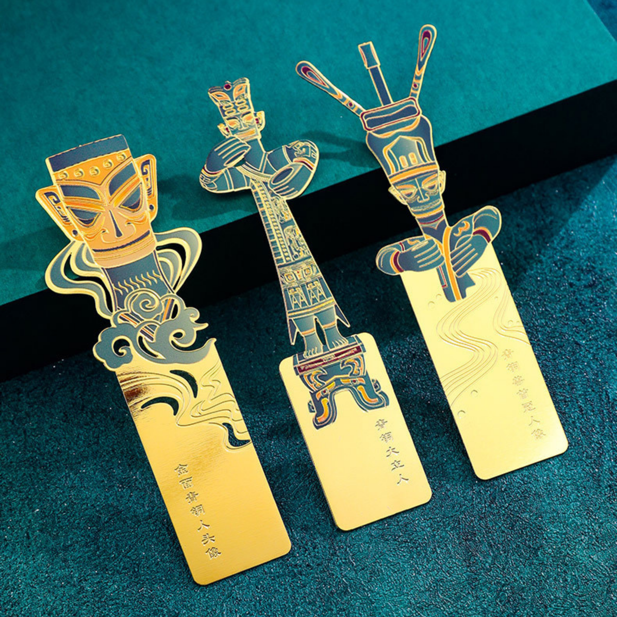 Decorative bookmarks with tribal designs on a textured blue surface