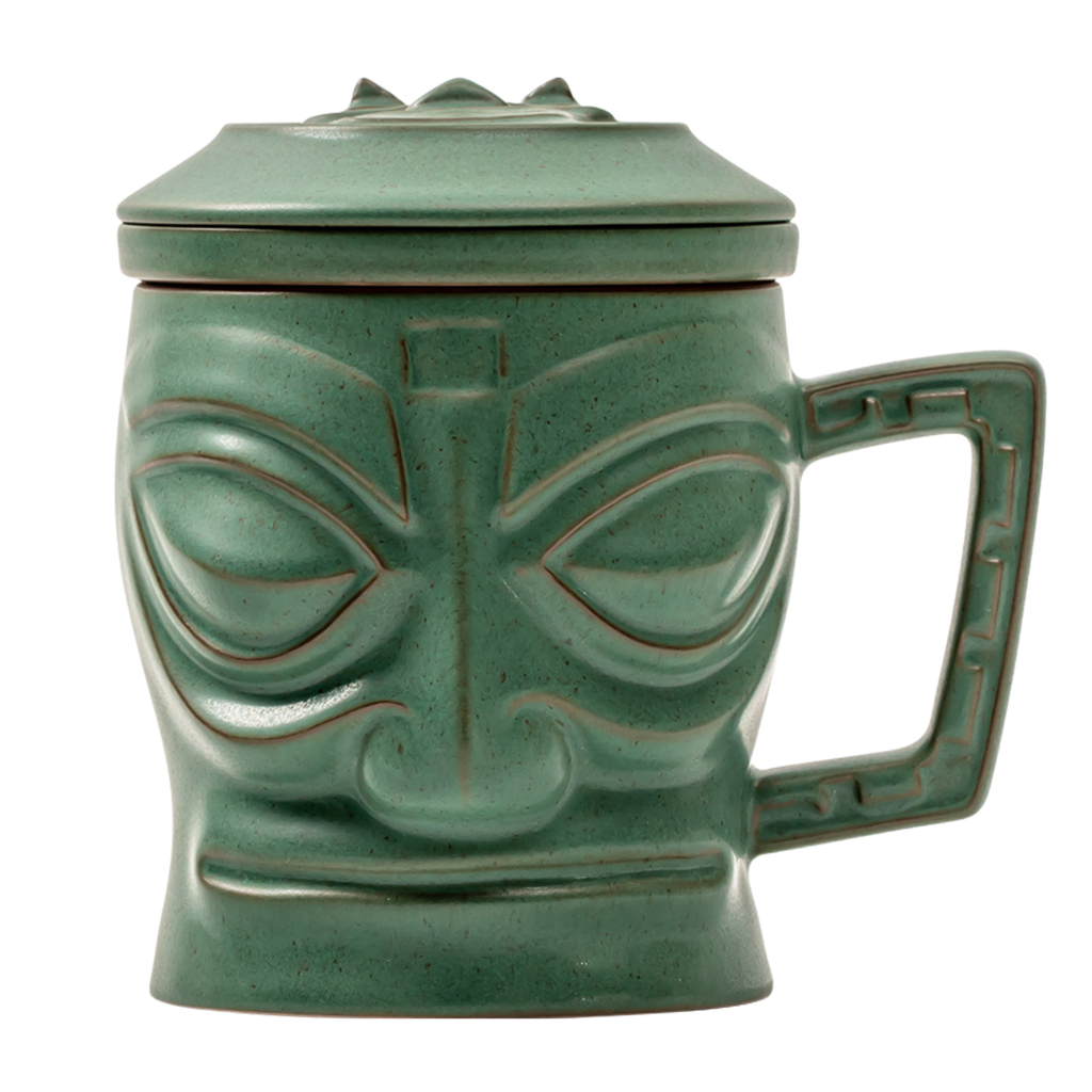 Green tiki mug with face design on a white background