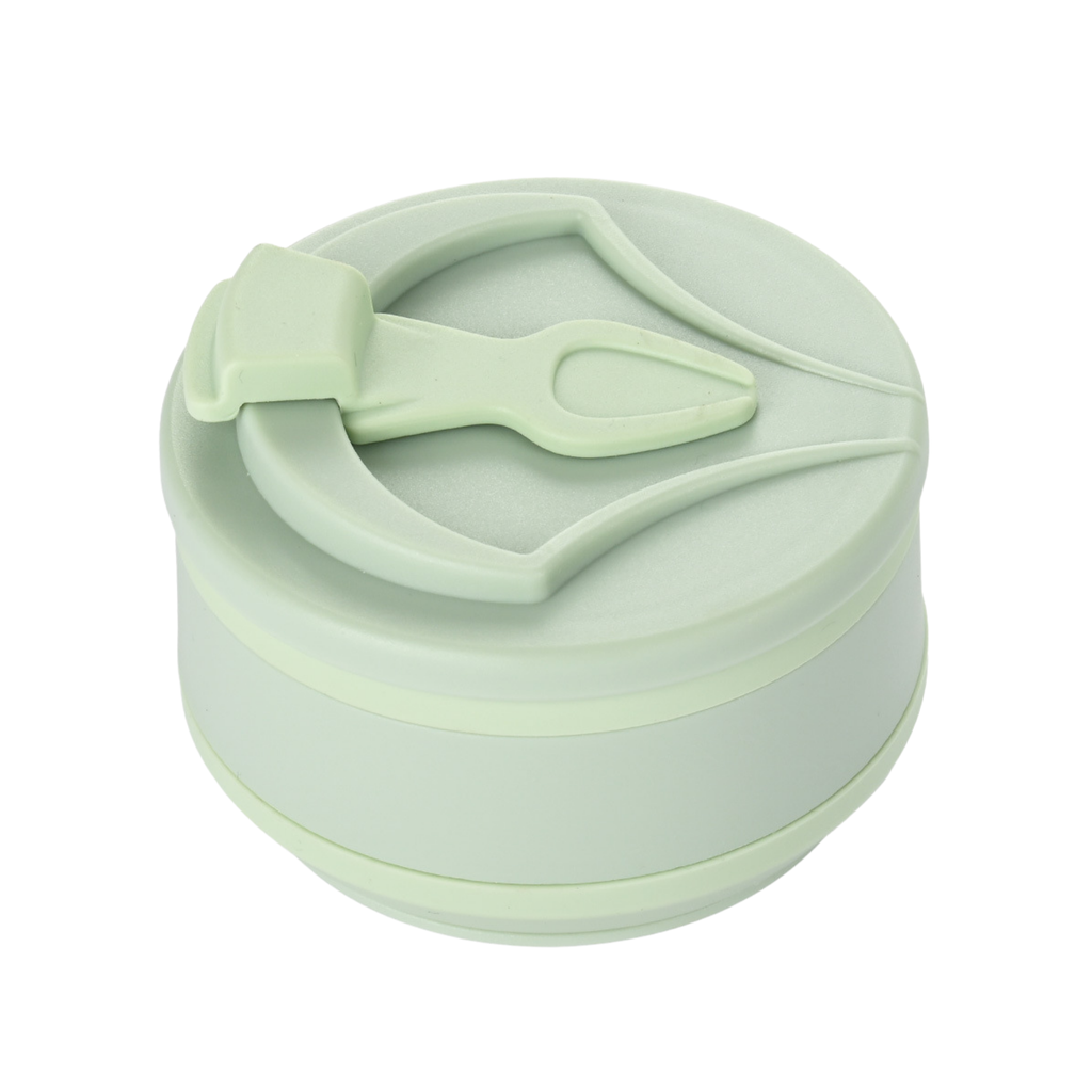 Light green silicone lid with spoon on a white background